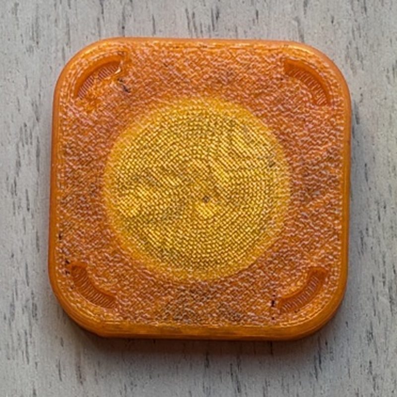 Handmade translucent orange 3D-printed NFC tag